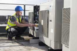 Technician doing maintenance on an HVAC system