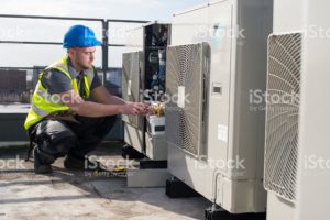 Stock image of a man working on a HVAC system